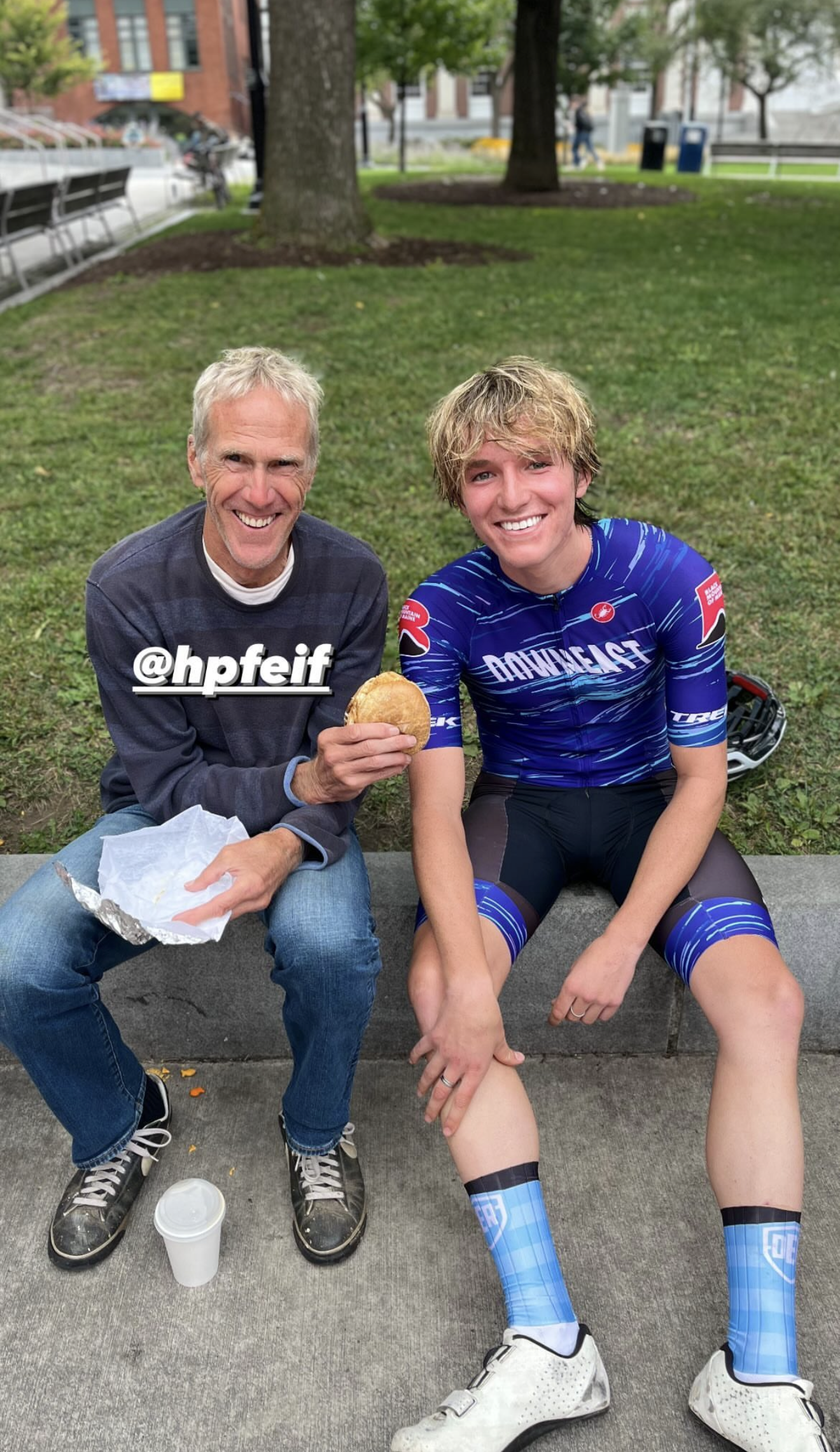 Heath Fellows in a blue kit sharing a post-ride snack on a curb